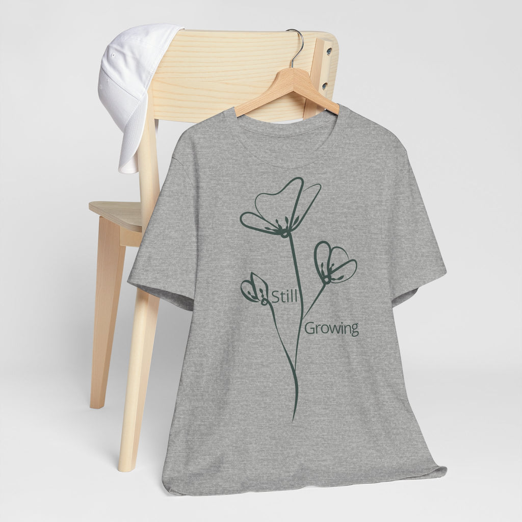Still Growing Floral T-Shirt by Printify featuring a minimalist floral design on a casual, comfortable cotton tee.