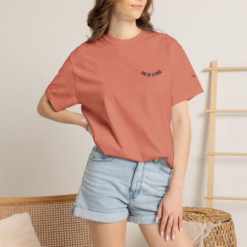 Black "One of a Kind" Chest Logo T-shirt by Printify featuring a minimalist design on the front.