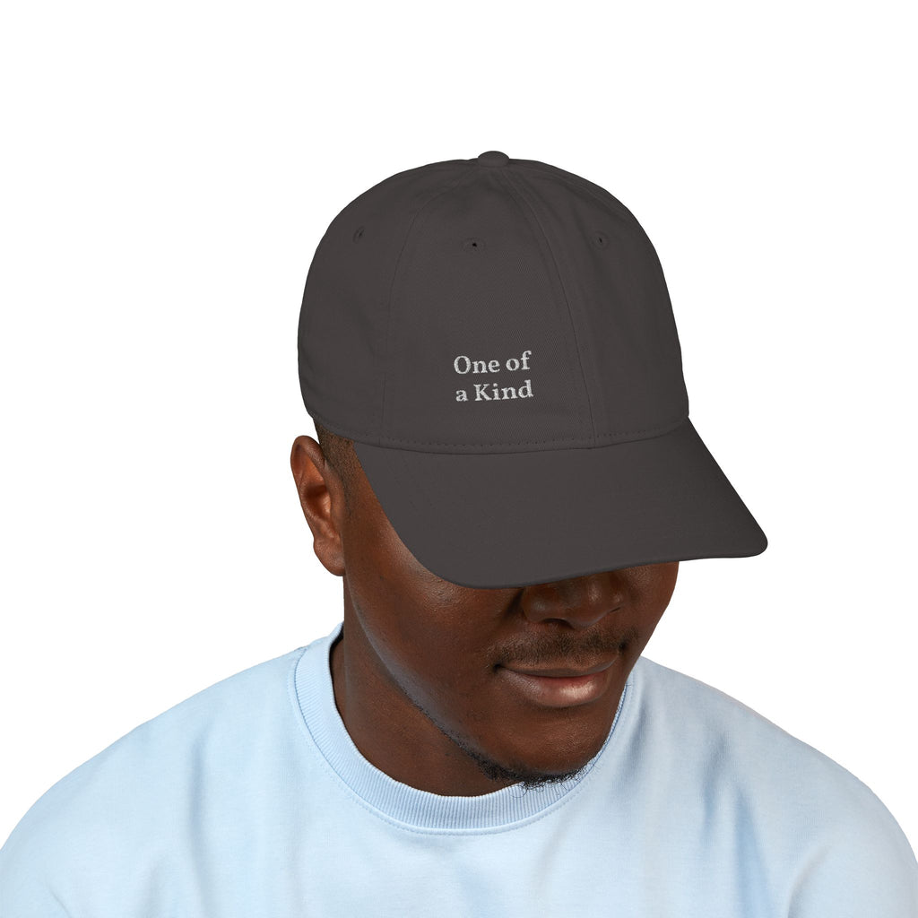 Organic embroidered baseball cap with "One of a Kind" design, casual style, breathable fabric, and adjustable strap by Printify.