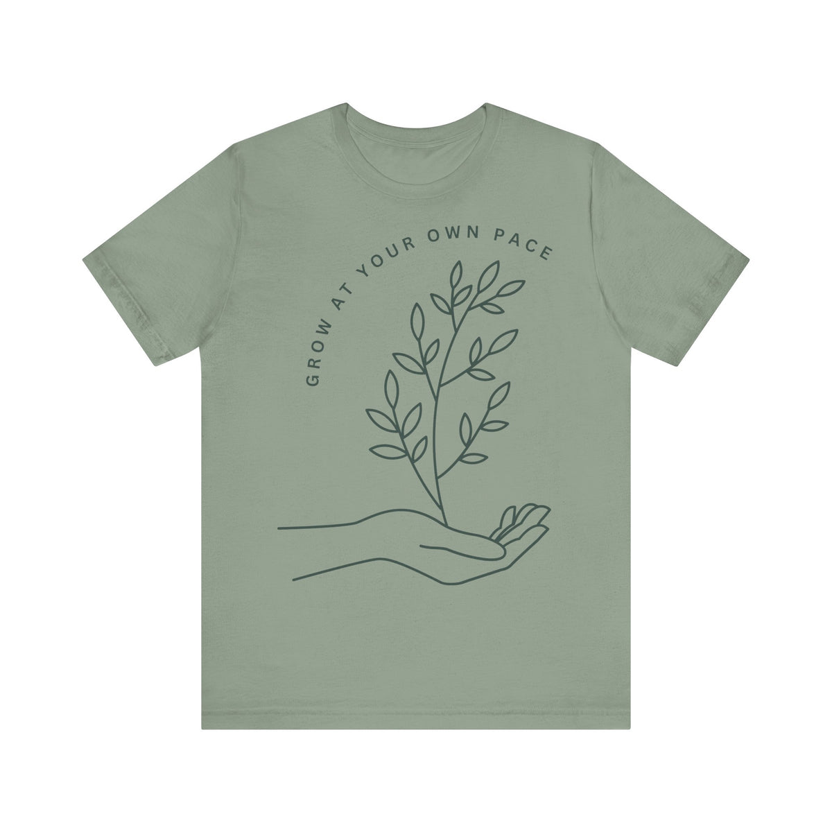 Minimal botanical print T-shirt with "Grow At Your Own Pace" slogan, featuring a green plant design on a casual tee.