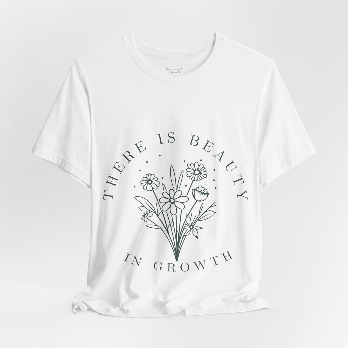 Printify floral T-shirt featuring "There Is Beauty In Growth" design, showcasing vibrant flowers on a casual tee.