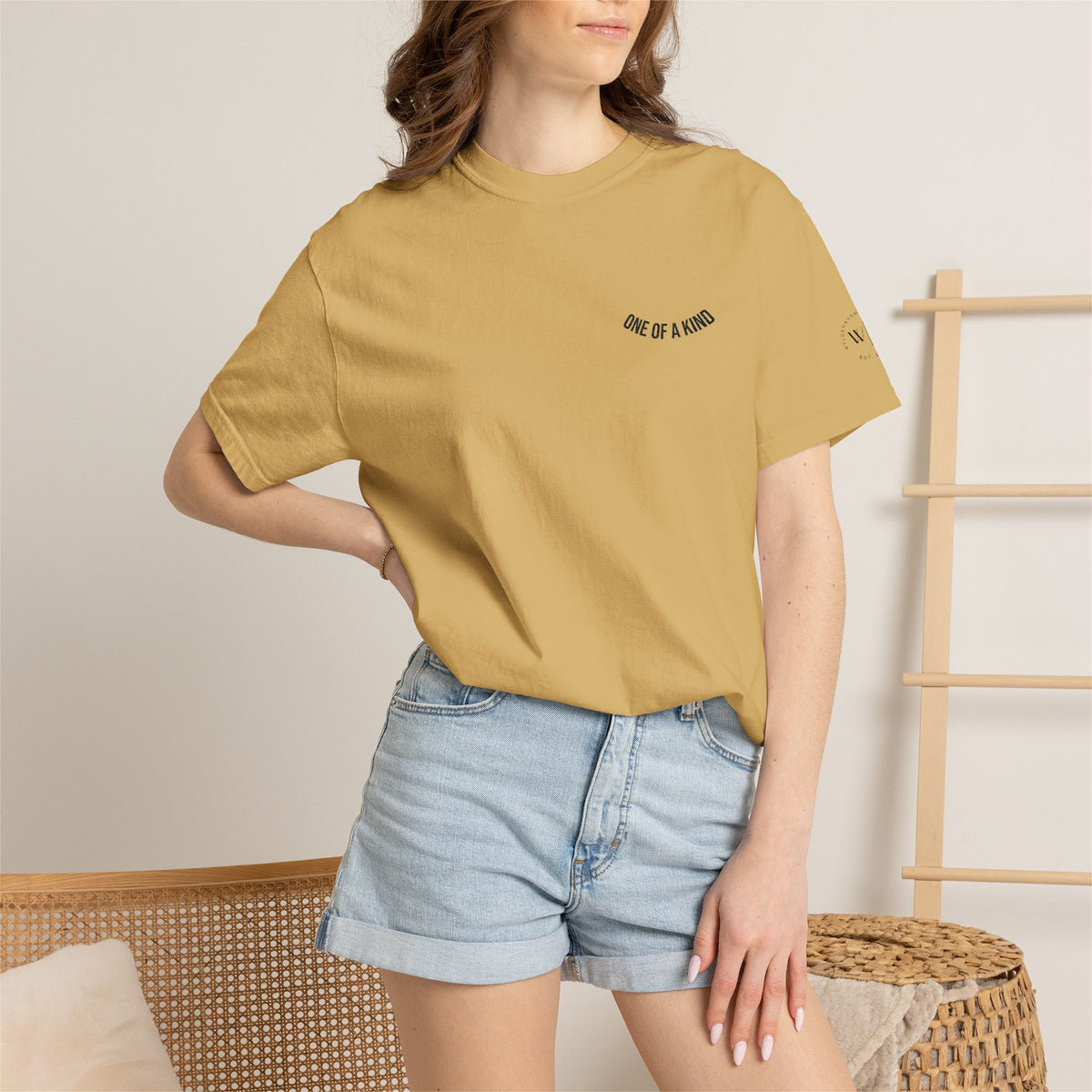 Black "One of a Kind" Chest Logo T-shirt by Printify featuring a minimalist logo design on the front.