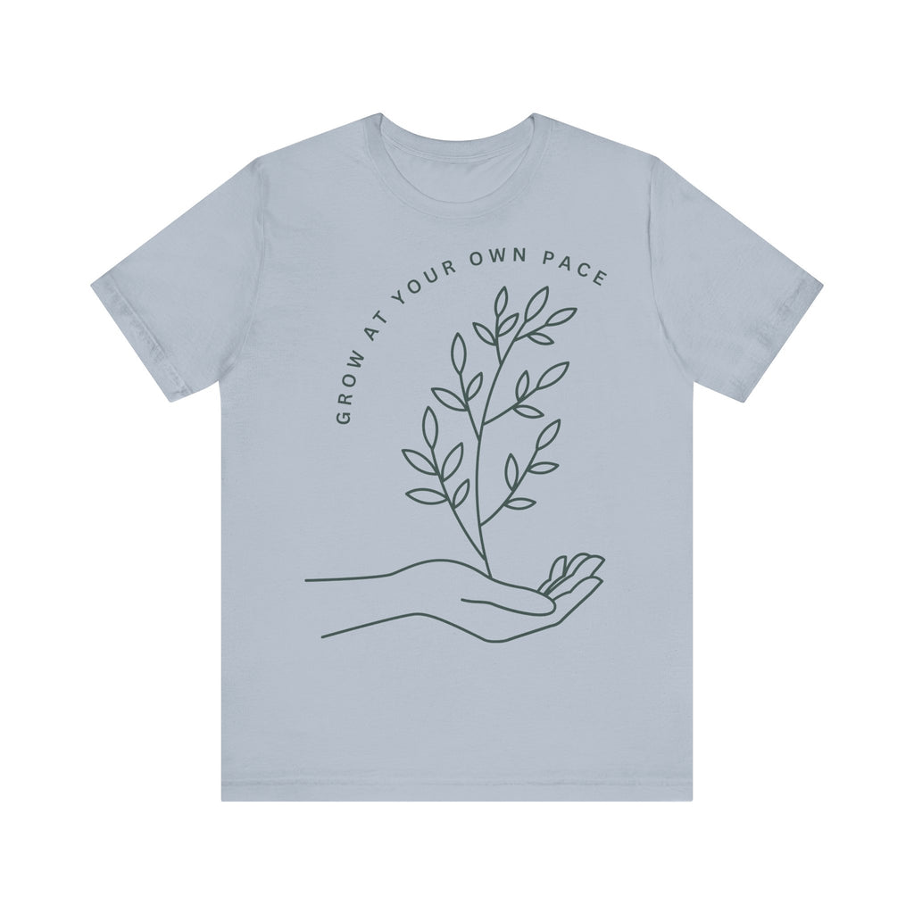 Minimal botanical print t-shirt with "Grow At Your Own Pace" slogan, made by Printify, featuring a simple plant design.