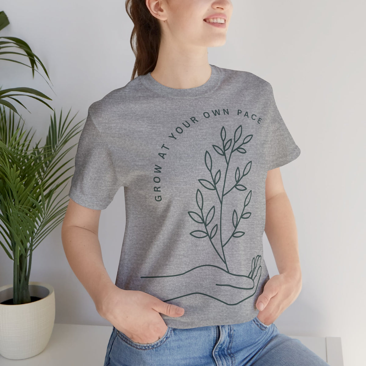 Minimal botanical print T-shirt by Printify featuring "Grow At Your Own Pace" slogan on a casual cotton tee.