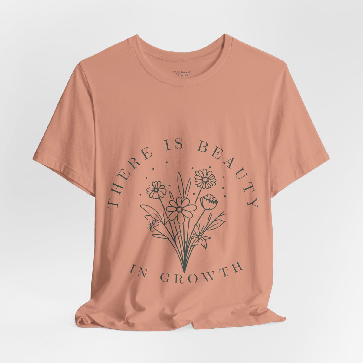 Printify floral T-shirt with "There Is Beauty In Growth" graphic, featuring vibrant flower designs on a casual cotton tee.