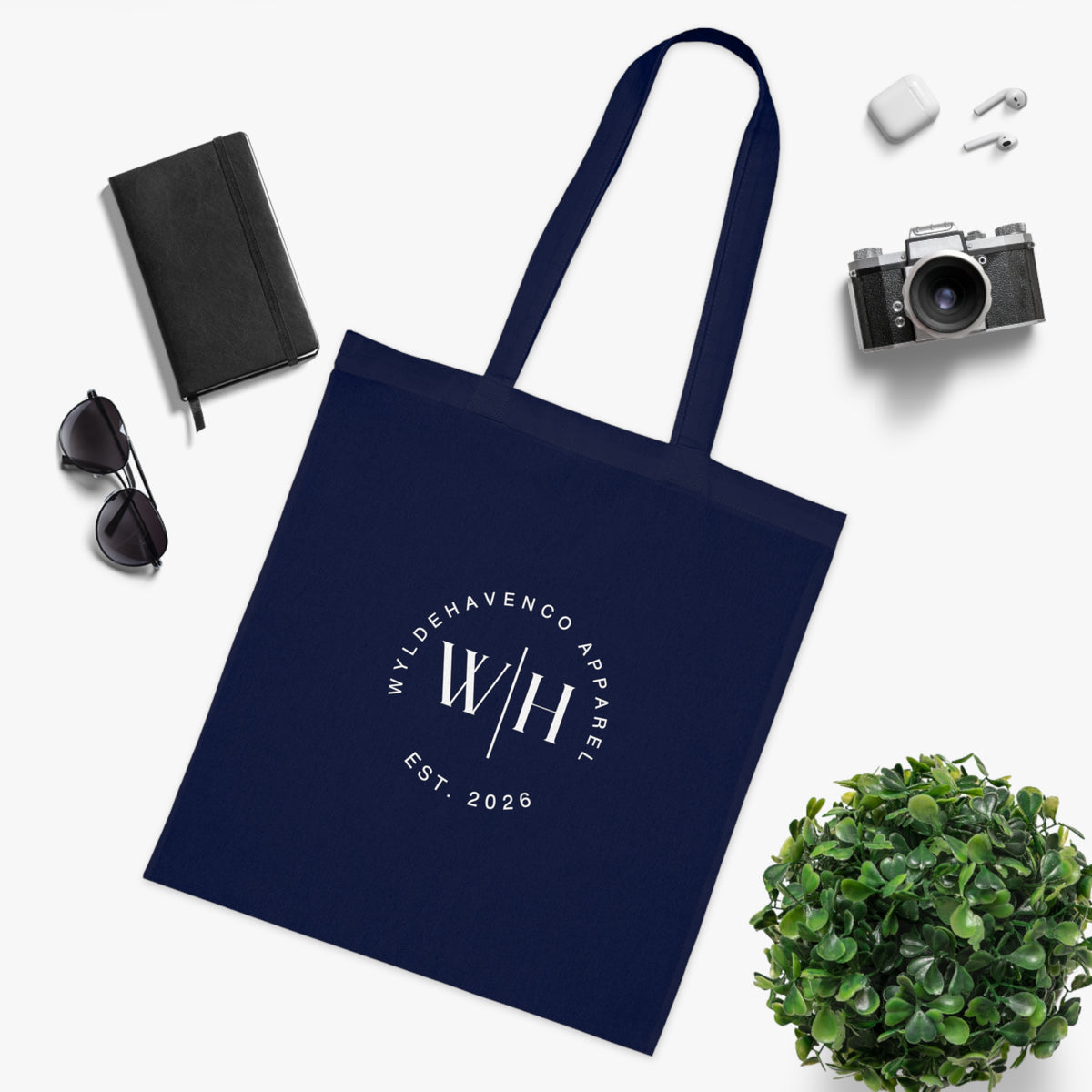 White cotton tote bag with monogram circle design and WH logo, casual canvas tote from Printify featuring durable handles.