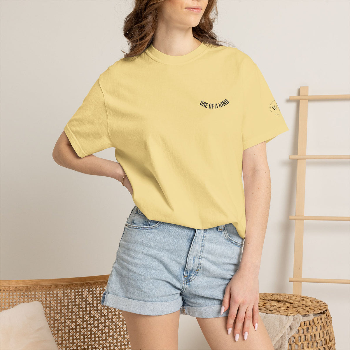 Black "One of a Kind" chest logo T-shirt by Printify, featuring a minimalist design on soft cotton fabric.